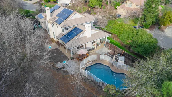 an aerial view of a house with a yard