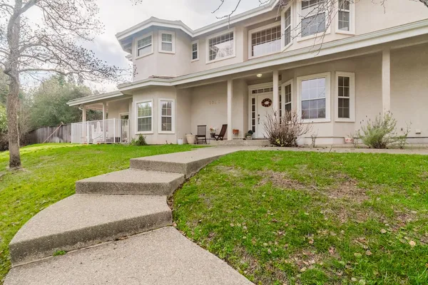 a front view of a house with a yard