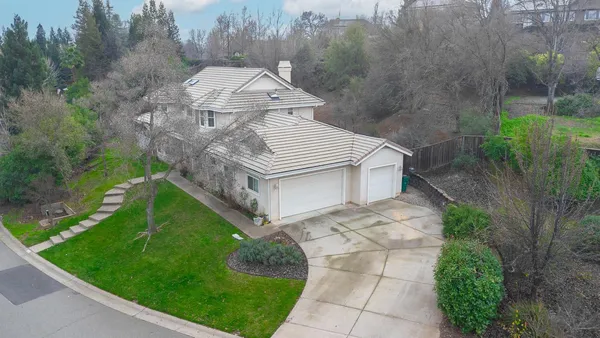 a aerial view of a house with roof deck front of house