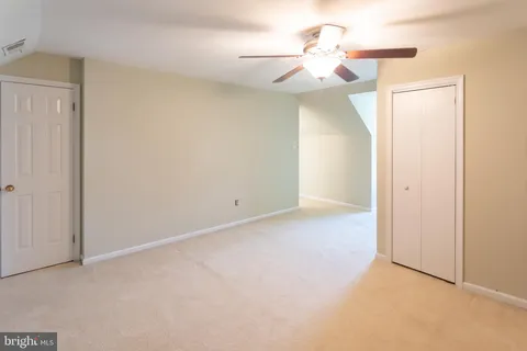 a view of a room with a ceiling fan and a window