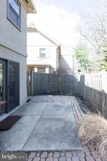 a view of backyard with wooden fence