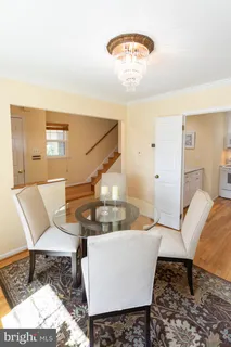 a living room with a couch and a chandelier