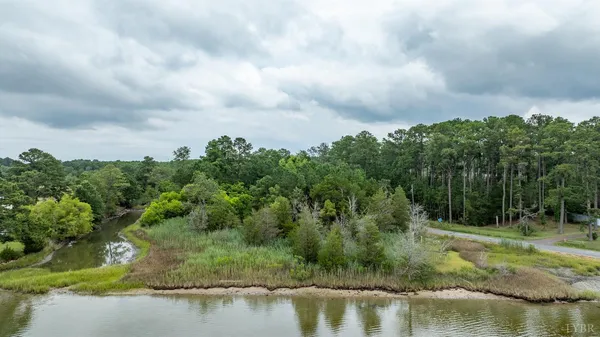 a view of a lake with houses in the back
