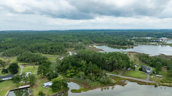 a view of a lake with houses in back