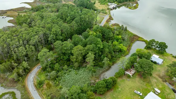 an aerial view of a residential houses with yard