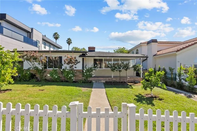 a view of a house with garden and sitting area