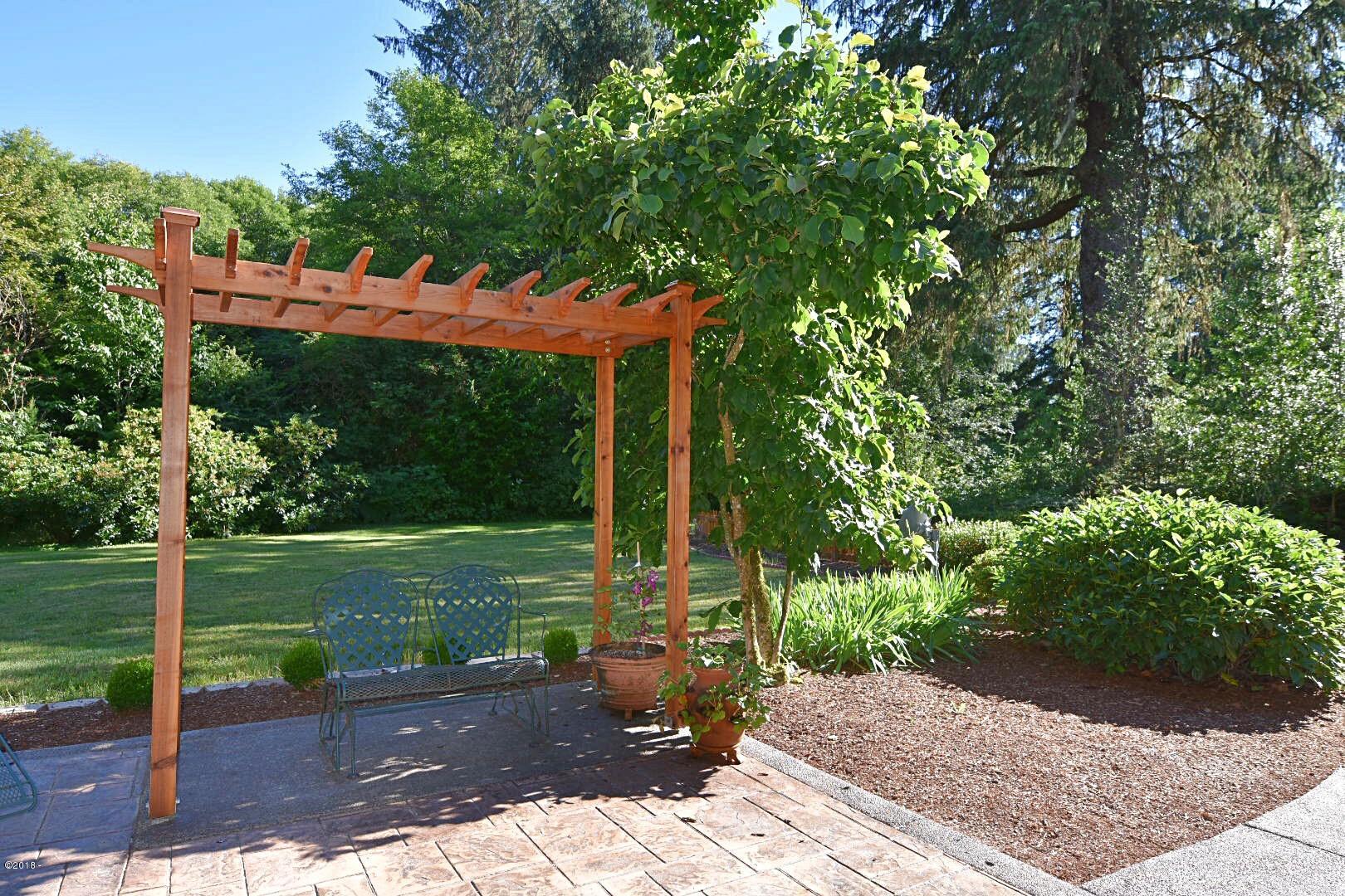 1754 Old River Road Northeast Siletz, OR 97380 - Photo 33 of 42 Trellis over Stamped Concrete Patio