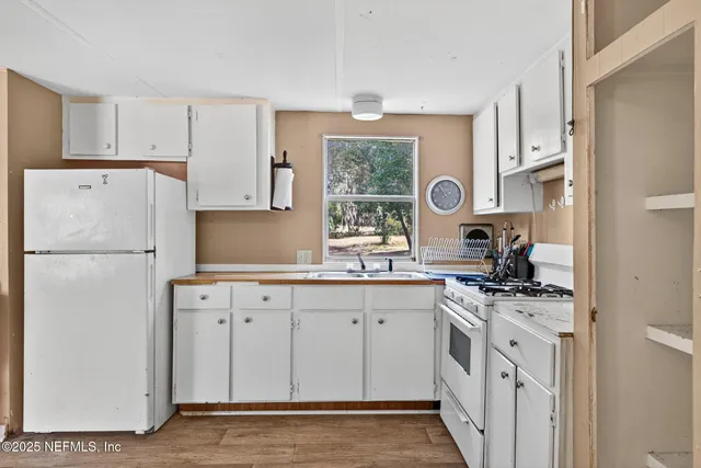 a kitchen with a stove top oven sink and cabinets