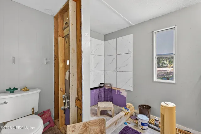 a view of a bathroom with sink mirror and wooden floor