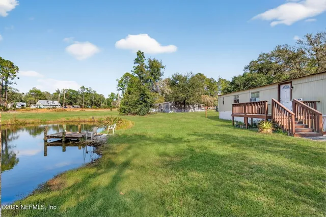 a backyard of a house with table and chairs