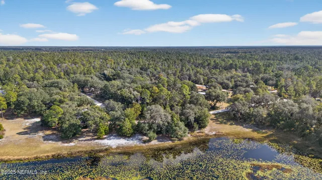 a view of a lake with a table and chairs