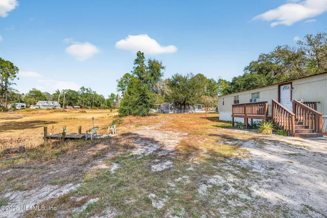 a view of a house with a yard and sitting area