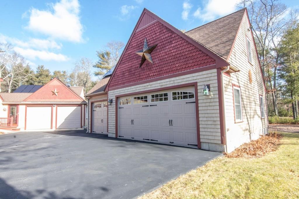 69 Cross Road Rochester, MA 02770 - Photo 3 of 33 a front view of a house with a yard and garage