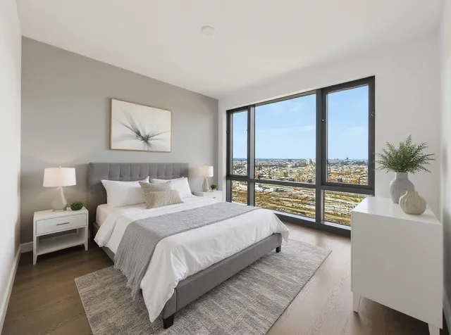 a spacious bedroom with a large bed and a large window