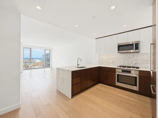 a kitchen with stainless steel appliances granite countertop a stove and a sink