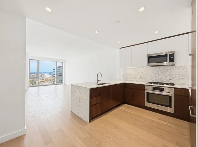 a kitchen with stainless steel appliances granite countertop a stove and a sink