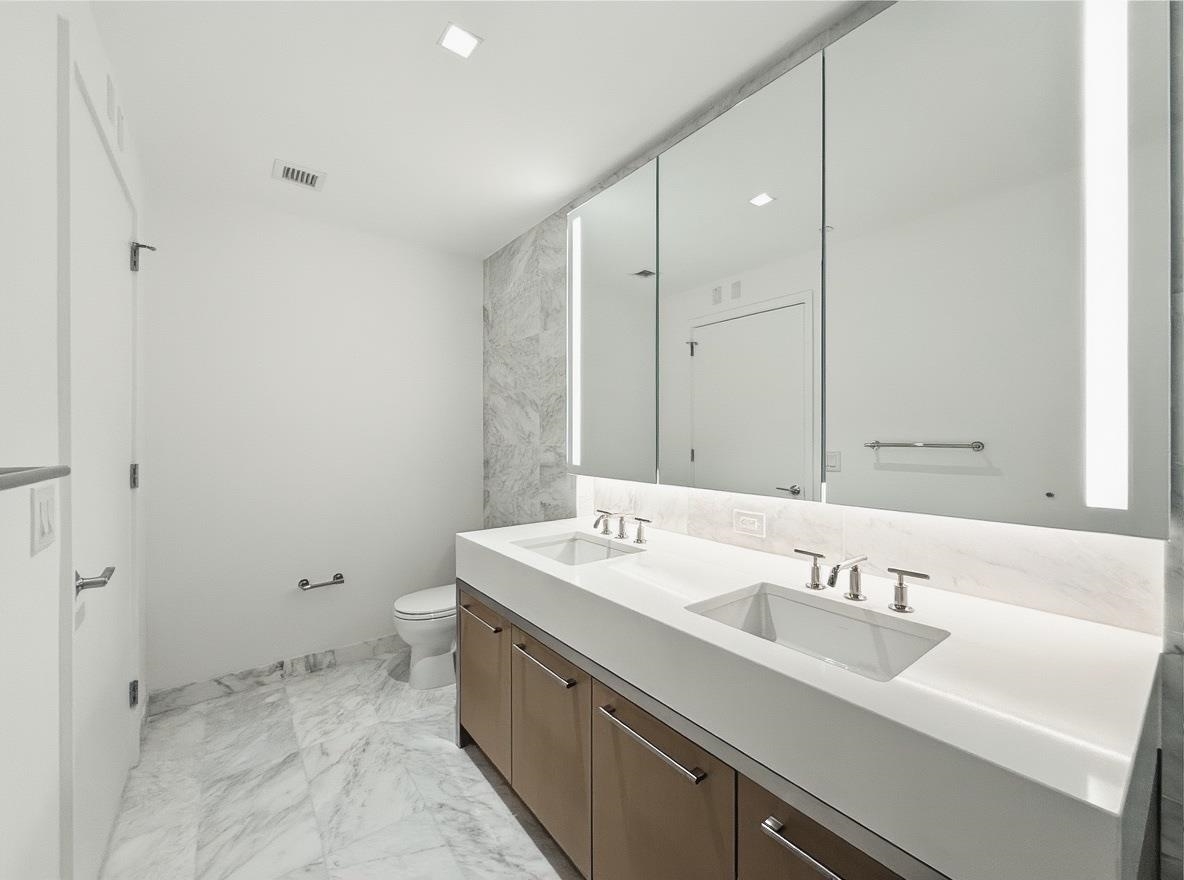 75 Park Lane South, Unit 3202 Jersey City, NJ 07310 - Photo 22 of 40 a bathroom with a sink and a mirror