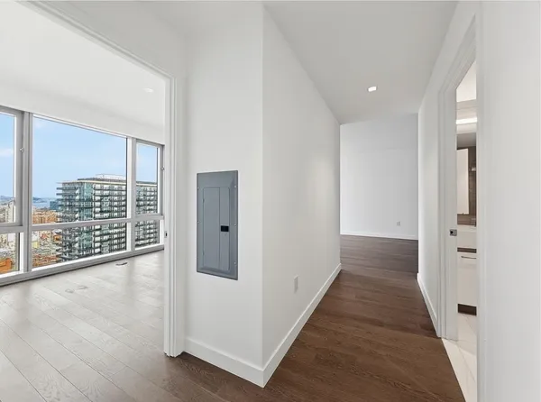 a view of hallway with wooden floor