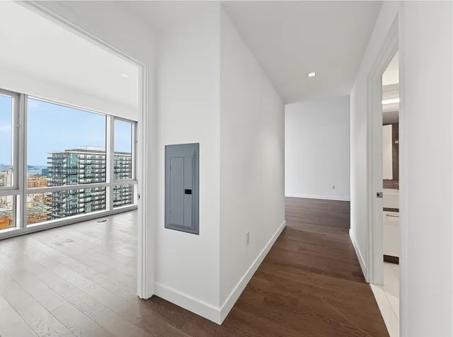 a view of hallway with wooden floor