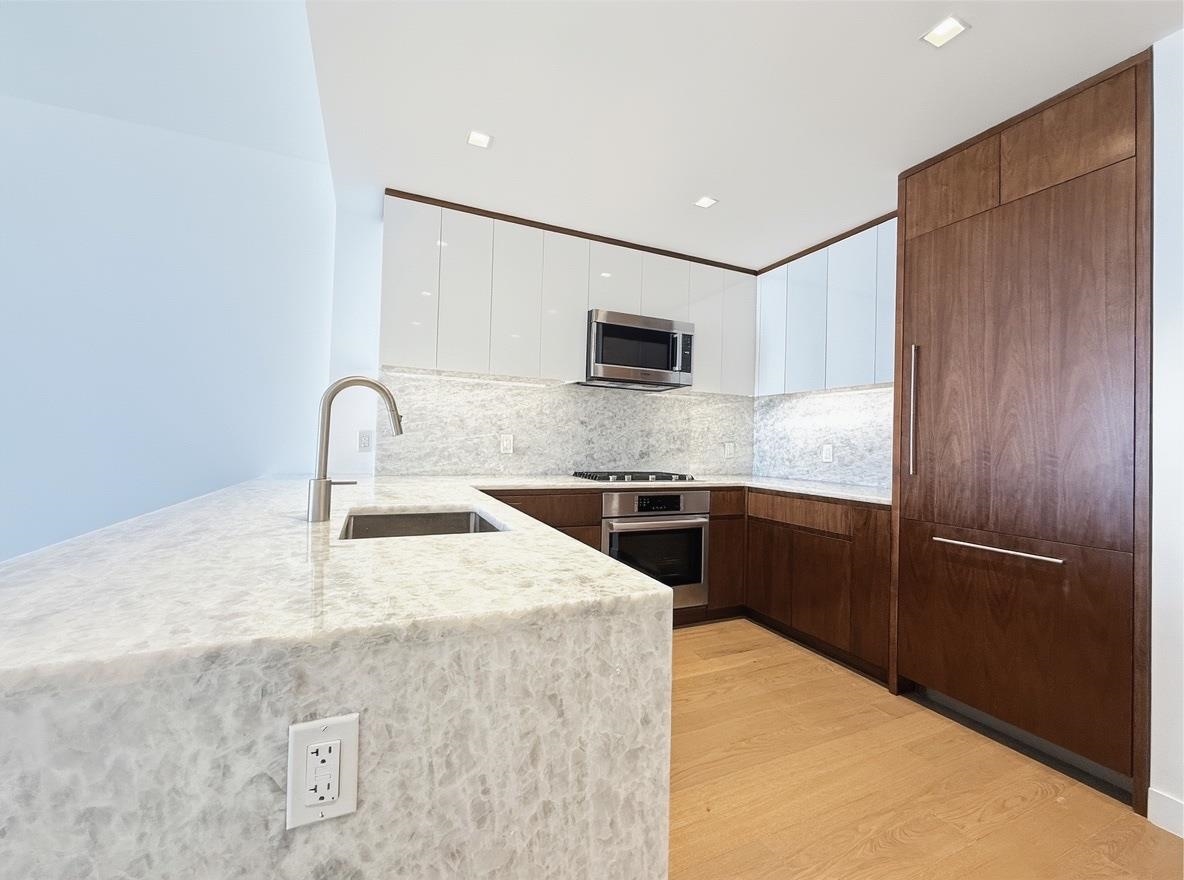 75 Park Lane South, Unit 3202 Jersey City, NJ 07310 - Photo 4 of 40 a kitchen with a refrigerator and a sink