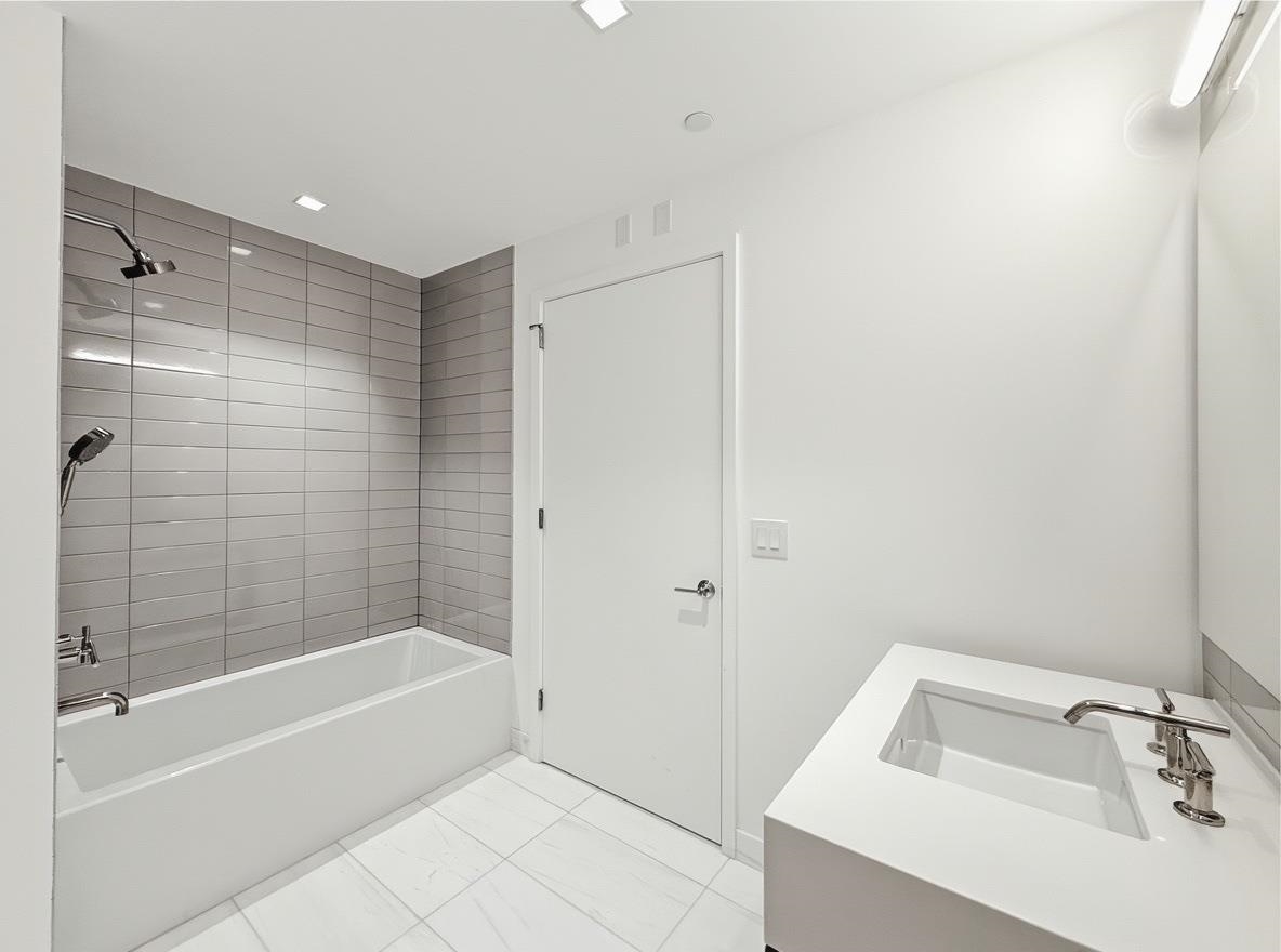 75 Park Lane South, Unit 3202 Jersey City, NJ 07310 - Photo 9 of 40 a bathroom with a tub shower and sink