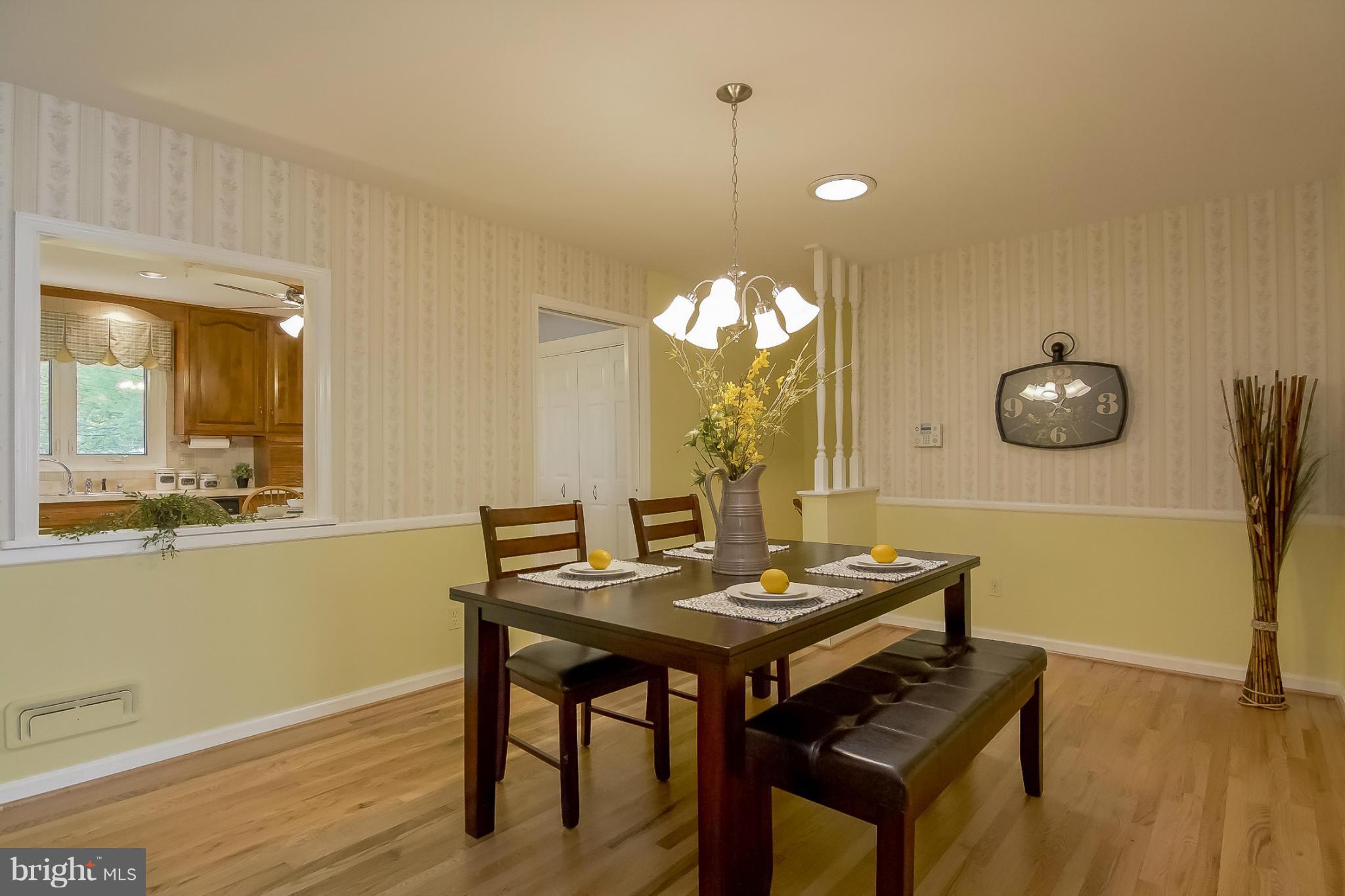 3704 Vega Road Randallstown, MD 21133 - Photo 6 of 25 a view of a dining room with furniture and wooden floor