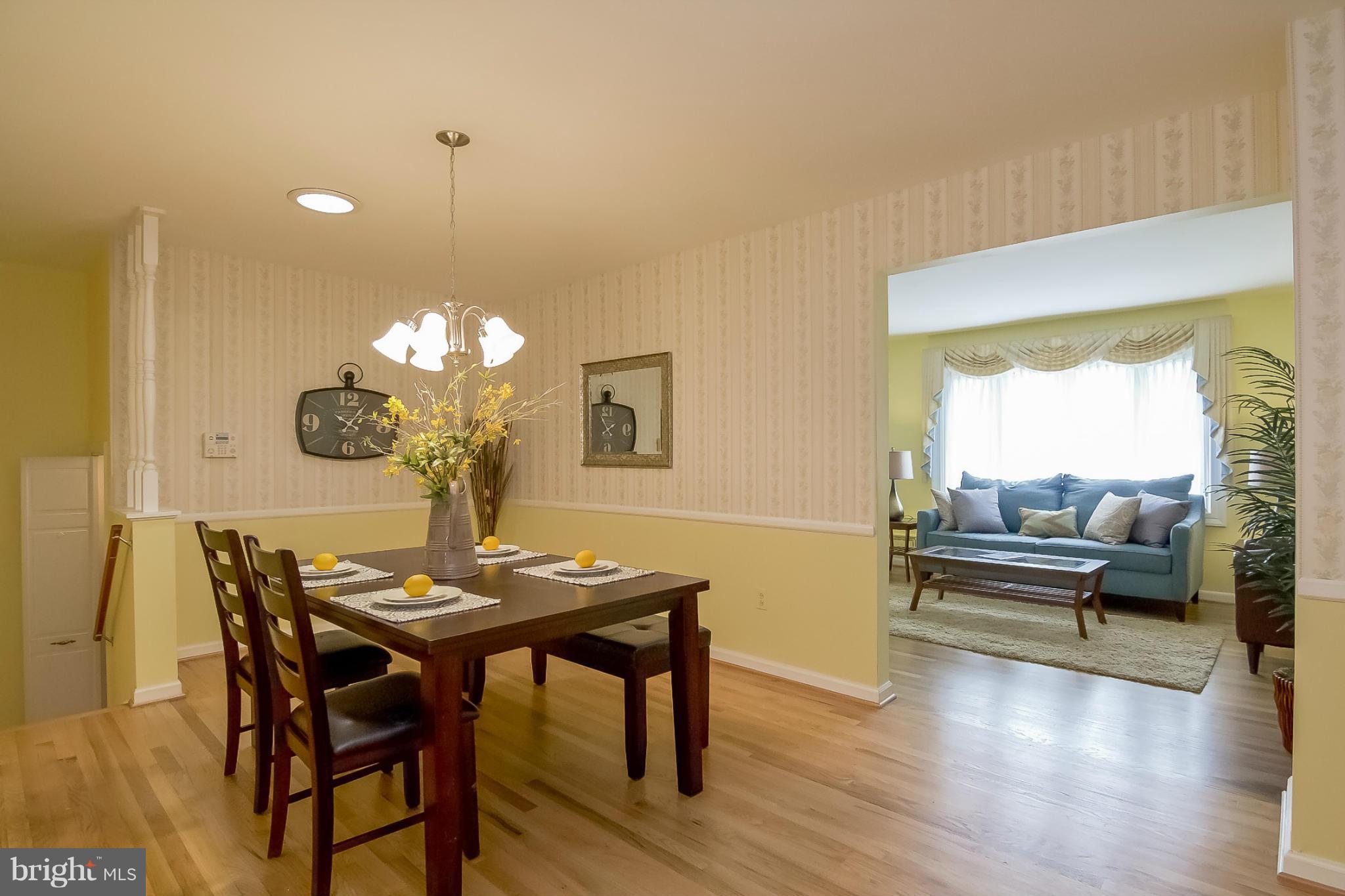 3704 Vega Road Randallstown, MD 21133 - Photo 7 of 25 a view of a dining room with furniture wooden floor and chandelier