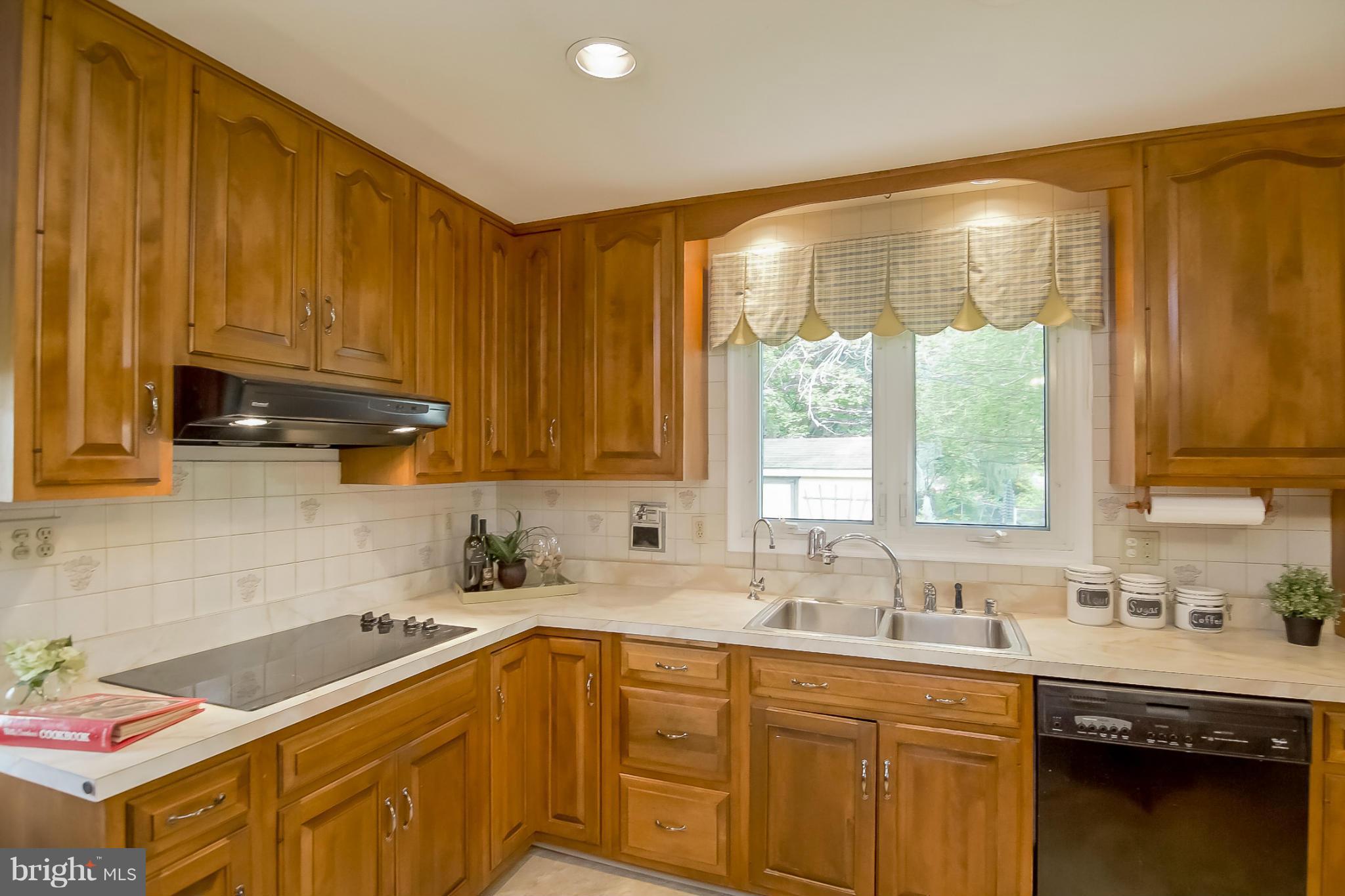 3704 Vega Road Randallstown, MD 21133 - Photo 9 of 25 a kitchen with a sink stove and cabinets
