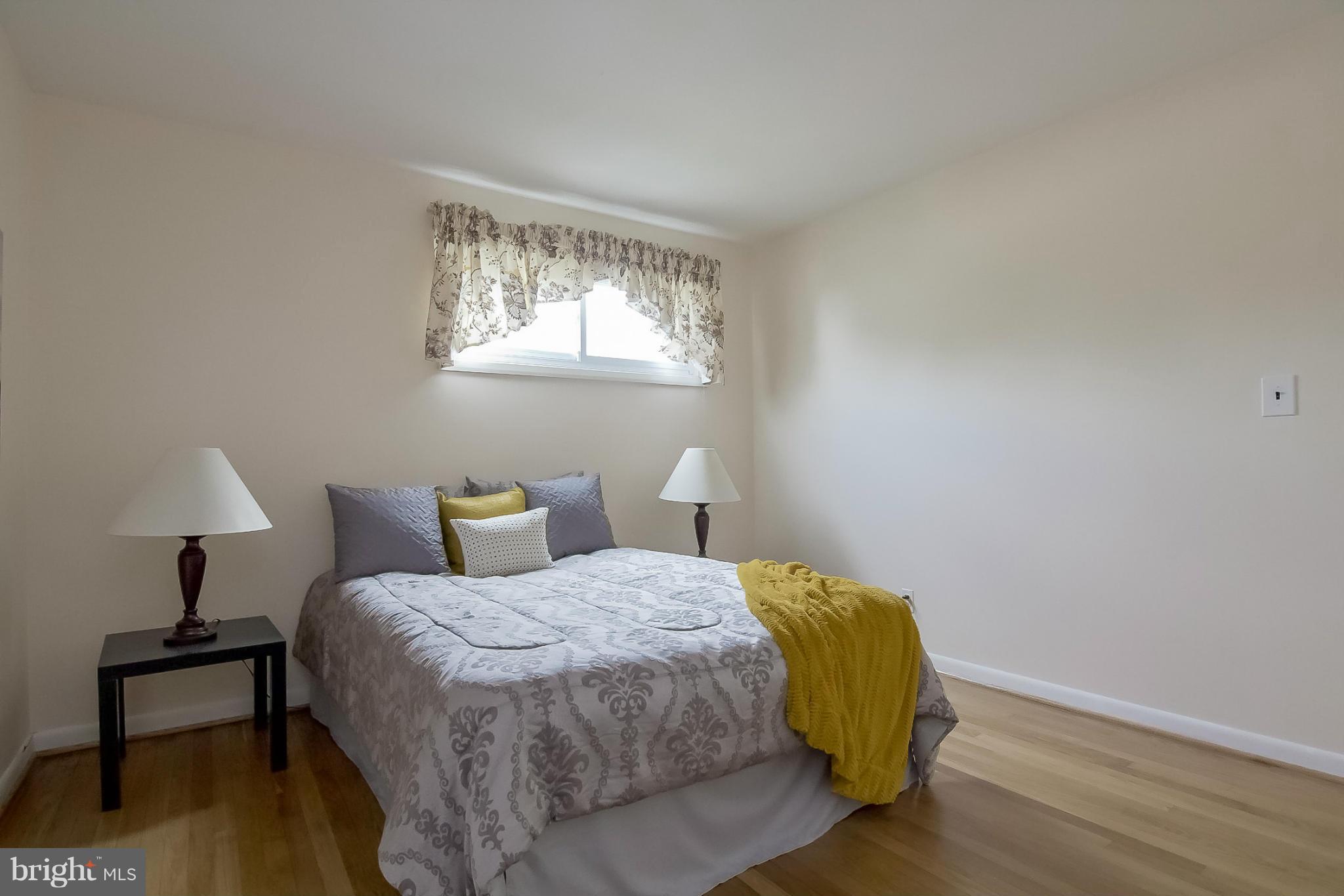 3704 Vega Road Randallstown, MD 21133 - Photo 10 of 25 a bedroom with a bed and a lamp on table