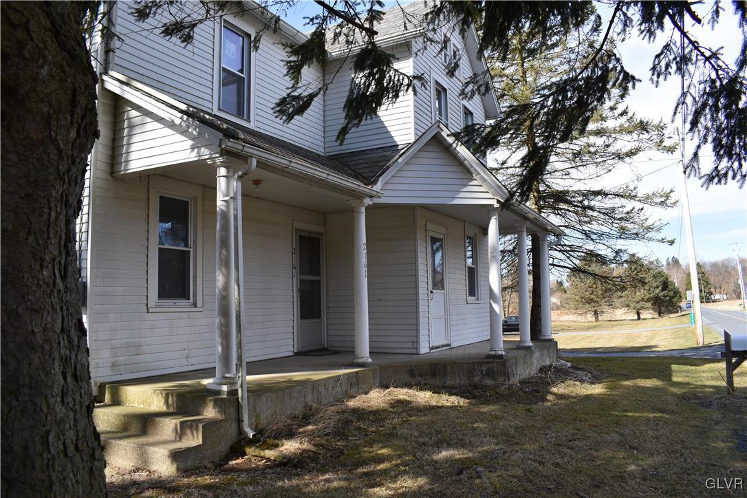 2161 East Scenic Drive Bath, PA 18014 - Photo 3 of 27 a front view of a house with a tree