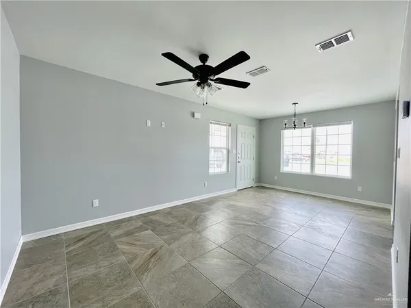 a view of room with a ceiling fan and window
