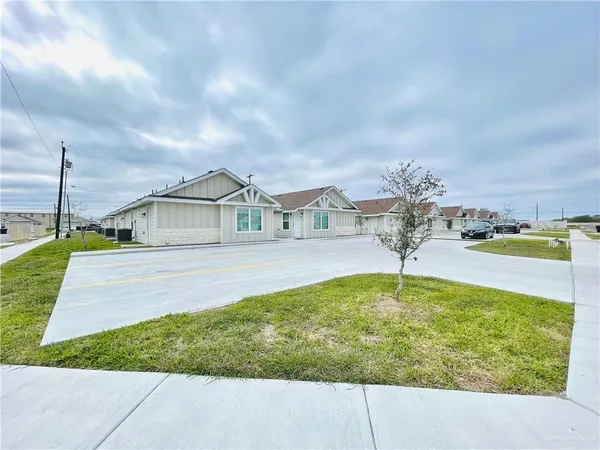 a kitchen with stainless steel appliances granite countertop a refrigerator a stove a sink and white cabinets