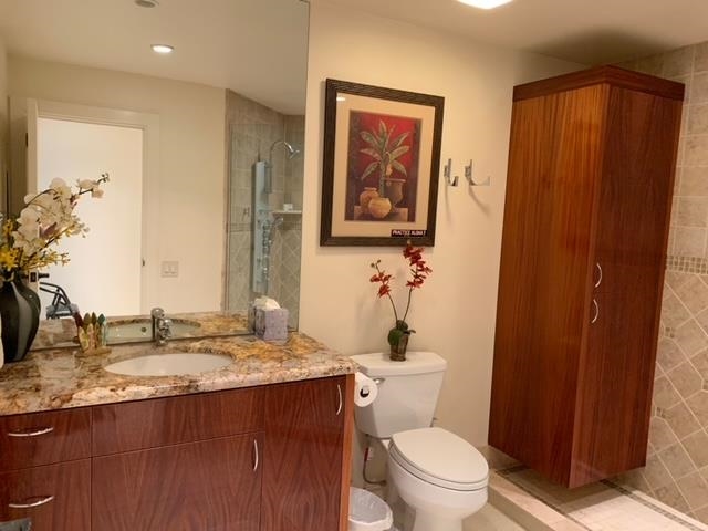50 Puu Anoano Street, Unit 1801 Lahaina, HI 96761 - Photo 4 of 8 a bathroom with a granite countertop sink toilet and shower