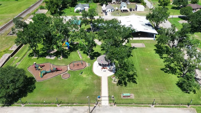 an outdoor space with seating area and trees all around