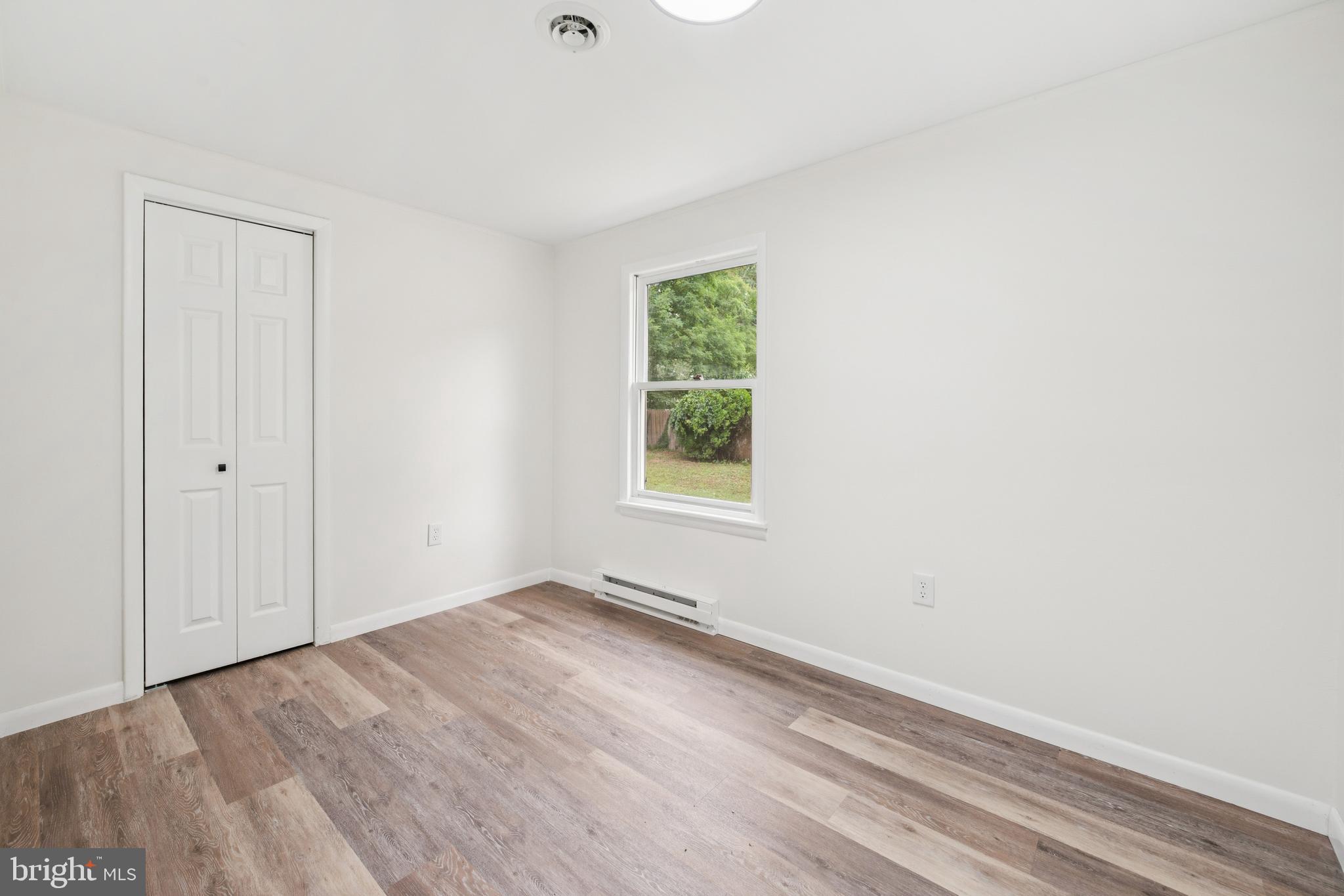 651 Erial Road Sicklerville, NJ 08081 - Photo 16 of 24 a view of an empty room with wooden floor and a window