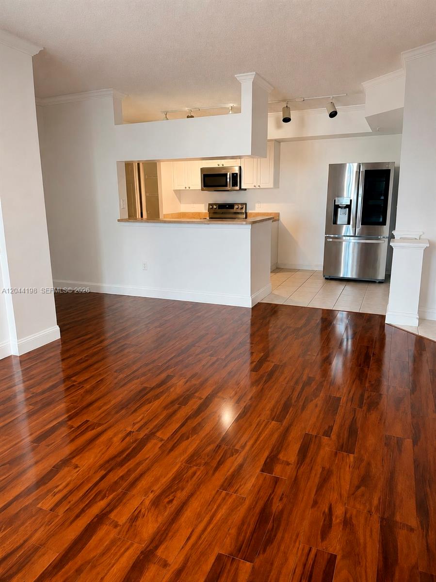 17145 North Bay Road, Unit 4307 Sunny Isles Beach, FL 33160 - Photo 12 of 35 a view of a kitchen with wooden floor and electronic appliances