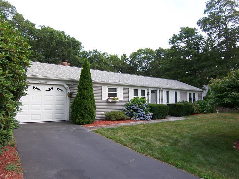 96 Sheaffer Road Centerville, MA 02632 - Photo 1 of 33 a front view of a house with a garden and plants
