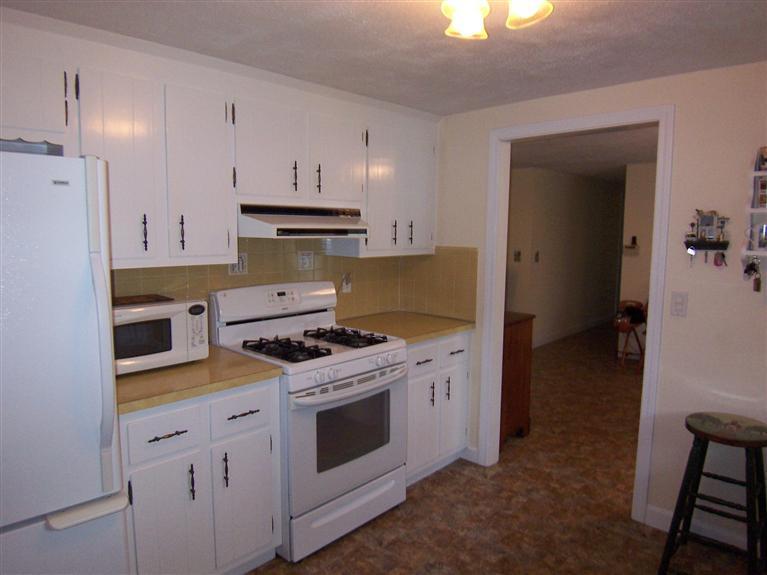 96 Sheaffer Road Centerville, MA 02632 - Photo 19 of 33 a kitchen with a stove top oven and cabinets