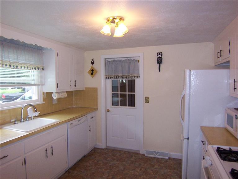 96 Sheaffer Road Centerville, MA 02632 - Photo 21 of 33 a kitchen with a sink refrigerator and cabinets