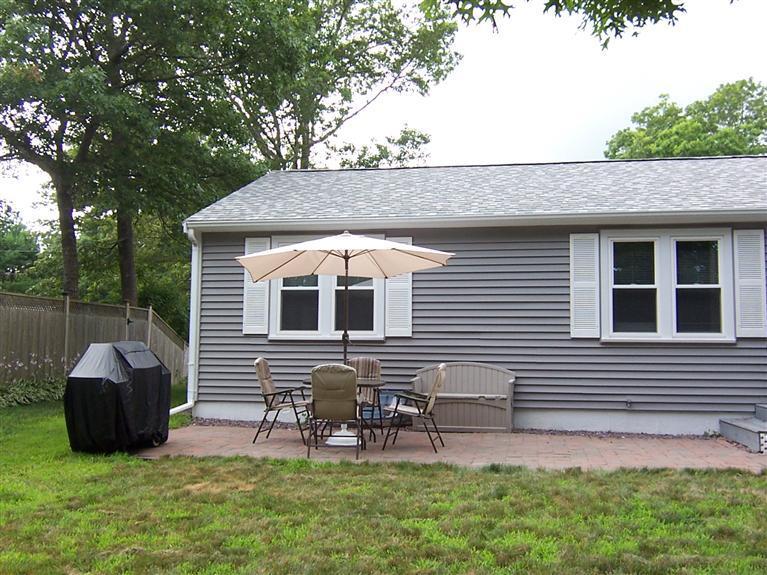 96 Sheaffer Road Centerville, MA 02632 - Photo 6 of 33 a backyard of a house with table and chairs
