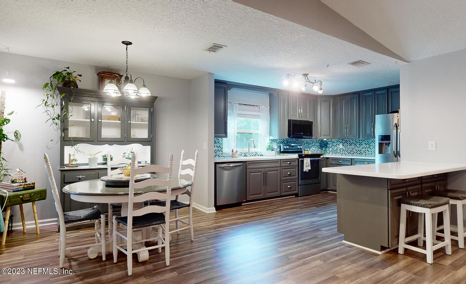 11338 Rustic Pines Circle East Jacksonville, FL 32257 - Photo 12 of 33 a kitchen with kitchen island granite countertop a table chairs sink and cabinets