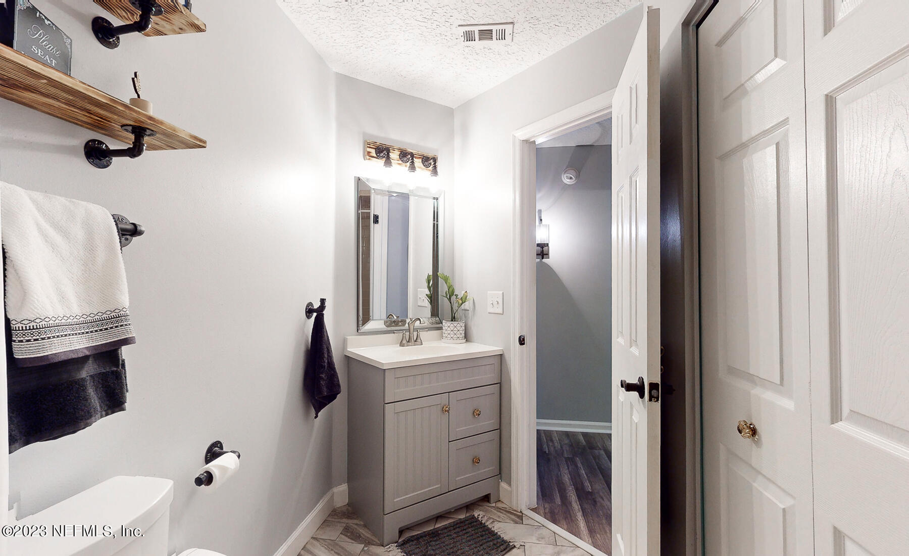 11338 Rustic Pines Circle East Jacksonville, FL 32257 - Photo 19 of 33 a bathroom with a sink a toilet and shower