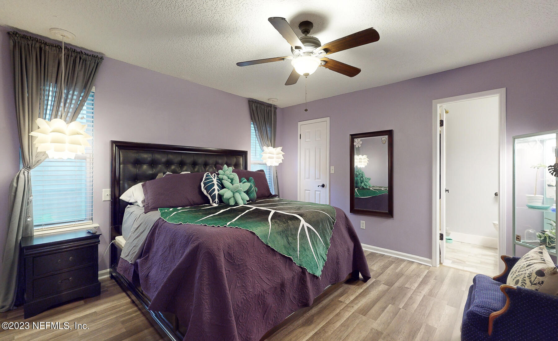 11338 Rustic Pines Circle East Jacksonville, FL 32257 - Photo 23 of 33 a bedroom with bed and a chandelier