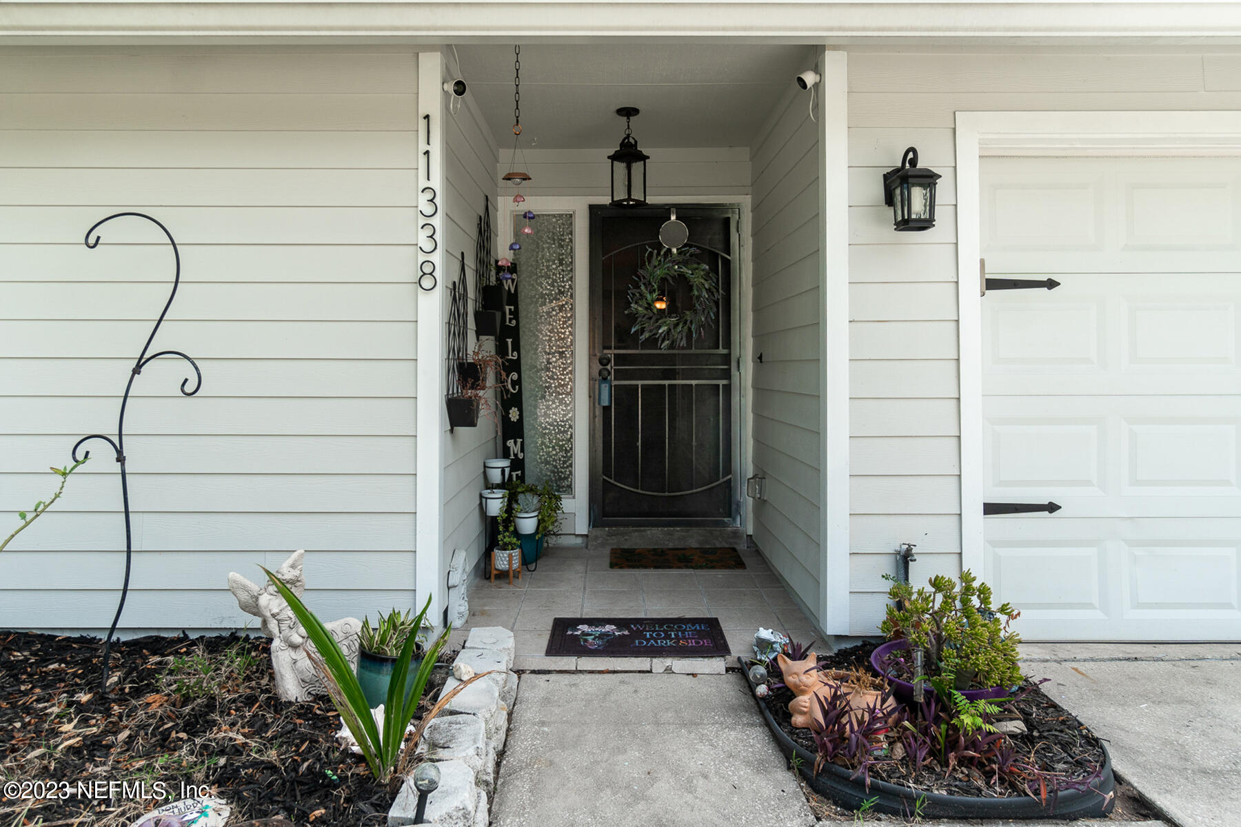 11338 Rustic Pines Circle East Jacksonville, FL 32257 - Photo 8 of 33 a front view of a house with a potted plant