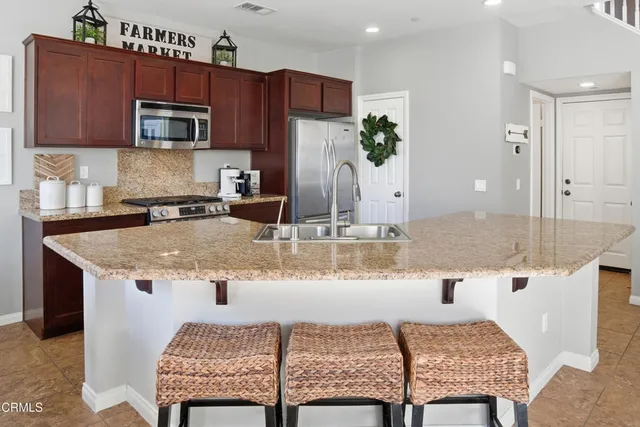 a kitchen with a stove a sink and a refrigerator