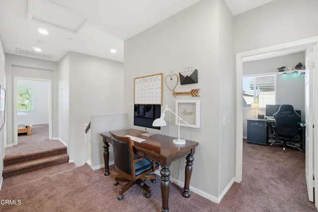 a livingroom with workspace and a couch