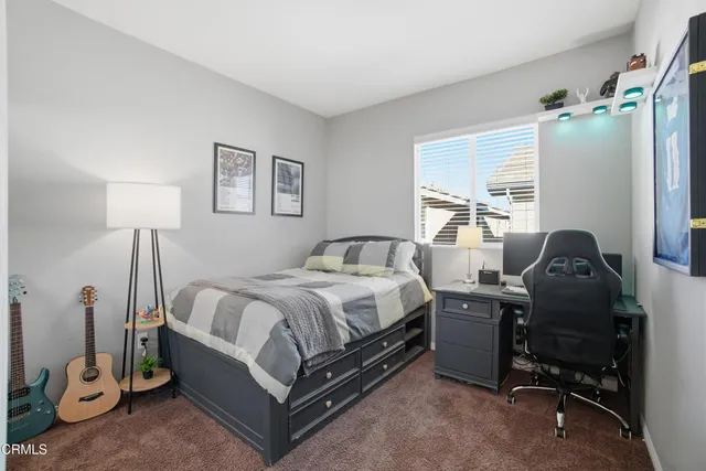 a bedroom with a bed and a desk