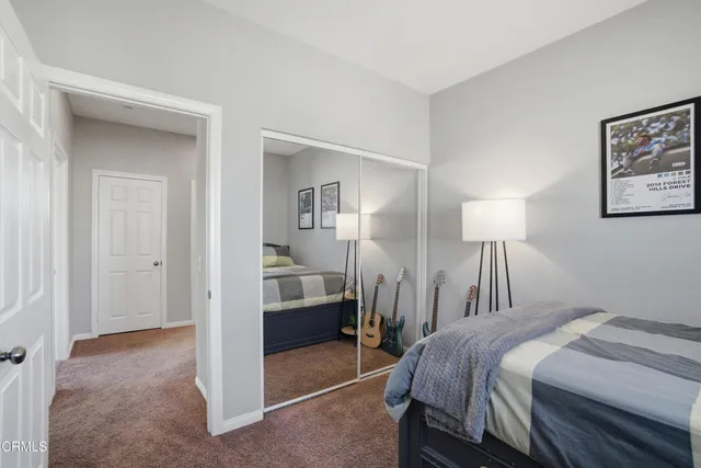 a bedroom with a bed and a mirror