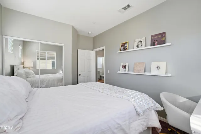 a bedroom with a bed and a chair