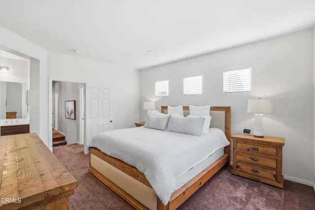 a bedroom with a bed and a lamp